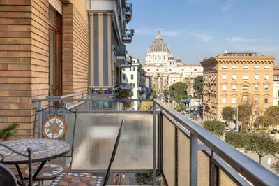a balcony with a table and a view of a city at Vista Indimenticabile sulla Cupola di S. Pietro in Rome