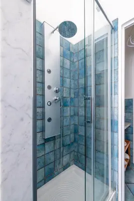a bathroom with a shower with blue tiles at Vista Indimenticabile sulla Cupola di S. Pietro in Rome