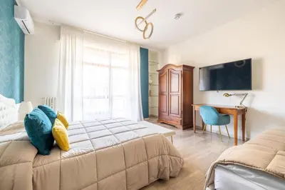 a bedroom with a bed and a desk and a computer at Vista Indimenticabile sulla Cupola di S. Pietro in Rome