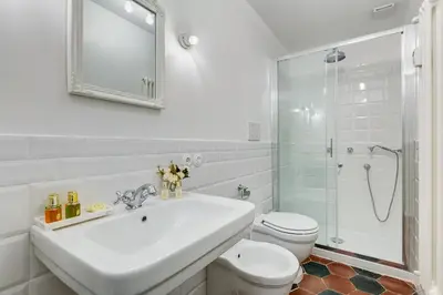 a bathroom with a sink and a toilet and a shower at Klioos Apartment Testaccio in Rome
