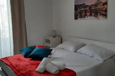 a white bed with two pillows on top of it at Caterina Apt San Lorenzo 2camere in Rome