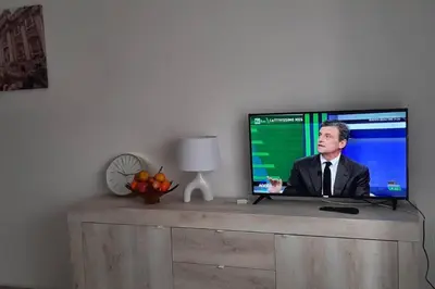 a flat screen tv sitting on top of a table at Caterina Apt San Lorenzo 2camere in Rome