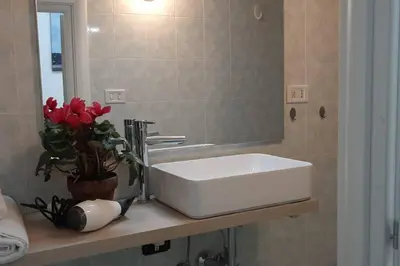 a bathroom with a white sink and a mirror at Caterina Apt San Lorenzo 2camere in Rome