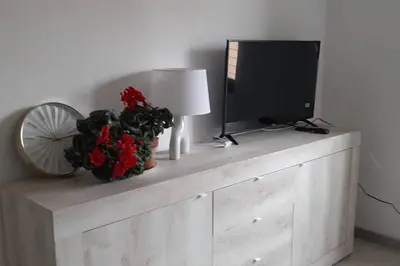 a wooden dresser with a television and a lamp at Caterina Apt San Lorenzo 2camere in Rome