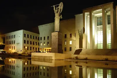 a building with a statue in front of it at night at Caterina Apt San Lorenzo 2camere in Rome