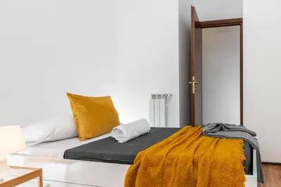 a bedroom with a bed with a yellow blanket at SkyView Home in Rome