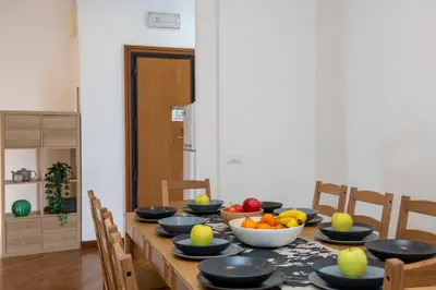 a dining room table with bowls of fruit on it at SkyView Home in Rome
