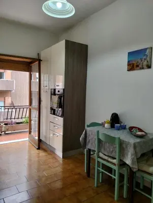 two beds in a room with green sheets and white cabinets at Home Sweet Home Tiburtina Station in Rome