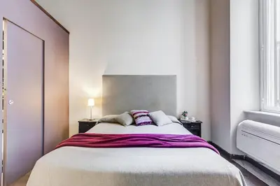 a bedroom with a large bed with two pillows at Roma Coronari a 2 minuti da piazza Navona in Rome