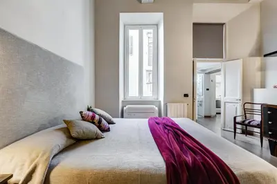 a bedroom with a large bed in a room at Roma Coronari a 2 minuti da piazza Navona in Rome