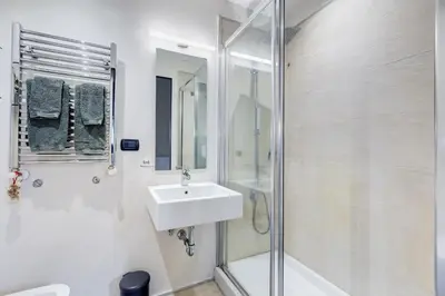 a white bathroom with a sink and a shower at Roma Coronari a 2 minuti da piazza Navona in Rome