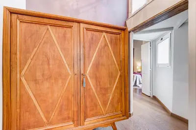 a wooden closet with a wooden door in a room at Roma Coronari a 2 minuti da piazza Navona in Rome