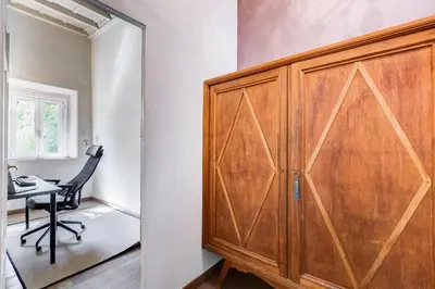 a wooden door in a room with a desk and a chair at Roma Coronari a 2 minuti da piazza Navona in Rome