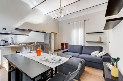 a living room with a table and a couch at Roma Coronari a 2 minuti da piazza Navona in Rome