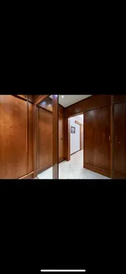 a hallway with wood paneling and a hallway with a door at Anastasio II apartment in Rome