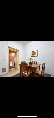 a dining room with a wooden table and chairs at Anastasio II apartment in Rome