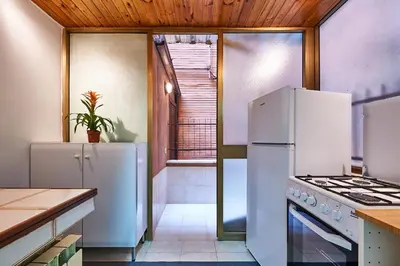 a kitchen with white appliances and a wooden ceiling at Anastasio II apartment in Rome