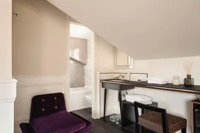 a bathroom with a purple chair and a sink at Palazzo Navona Hotel in Rome
