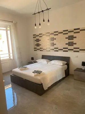 a bedroom with a large bed in a room at Candia House in Rome
