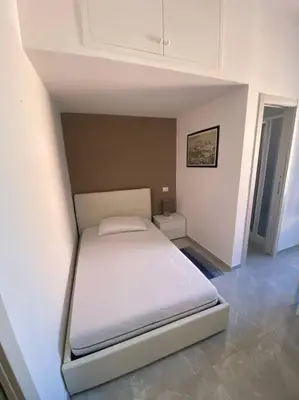 a bedroom with a white bed in a room at Candia House in Rome