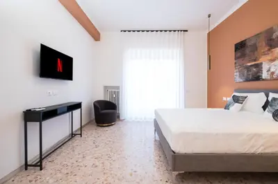 a bedroom with a bed and a desk and a window at Savoia Luxury Penthouse in Rome