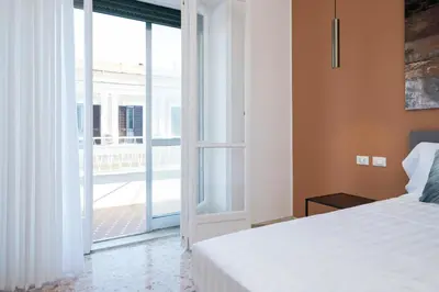 a bedroom with a bed and an open door at Savoia Luxury Penthouse in Rome