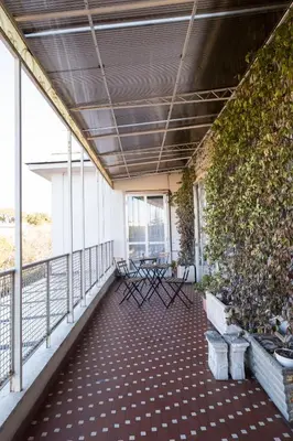 a balcony with chairs and plants on a building at Savoia Luxury Penthouse in Rome