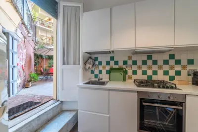 a room with a white door and pictures on the wall at GuestHost - Piazza di Roma Turquoise Apartment in Rome