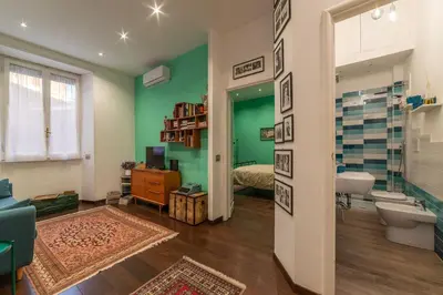 a kitchen with a sink and a stove top oven at GuestHost - Piazza di Roma Turquoise Apartment in Rome