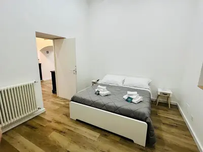 a bedroom with a bed with towels on it at Boiardo Art House in Rome