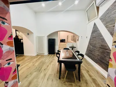 a dining room with a table and chairs at Boiardo Art House in Rome