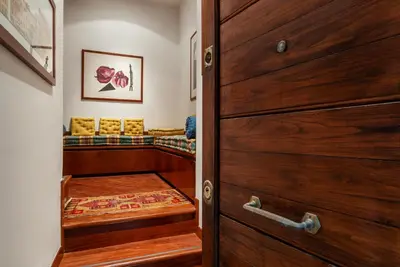 a room with a wooden door and a couch at GuestHost - Campo de Fiori Unique Apartment in Rome
