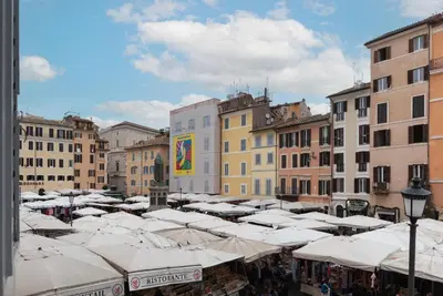 a group of white umbrellas in a city with buildings at GuestHost - Campo de Fiori Unique Apartment in Rome