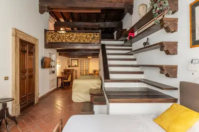 a staircase in a room with a living room at Historical Loft at Campo de Fiori in Rome
