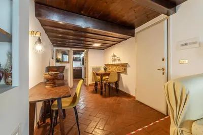 a kitchen and dining room with a table and chairs at Historical Loft at Campo de Fiori in Rome