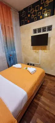 a bedroom with a large bed with a television on the wall at Wanderlust Pietralata B&B in Rome