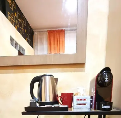 a tea kettle and coffee cups on a shelf at Wanderlust Pietralata B&B in Rome