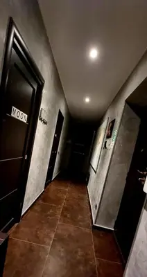a hallway of a building with a door and a tile floor at Wanderlust Pietralata B&B in Rome