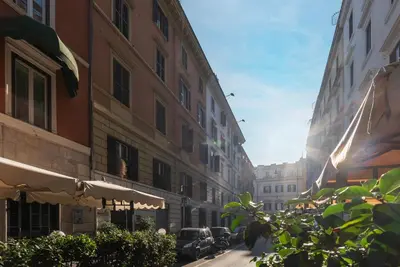 a city street with buildings and a street with cars at GuestHost - Termini Live Laugh & Love Apartment in Rome