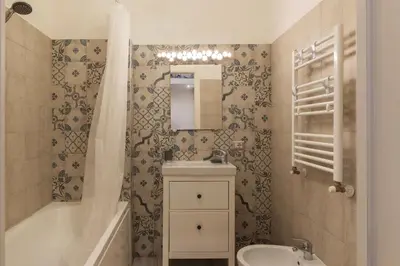 a bathroom with a sink and a toilet and a mirror at GuestHost - Casa Mariu' a San Pietro in Rome