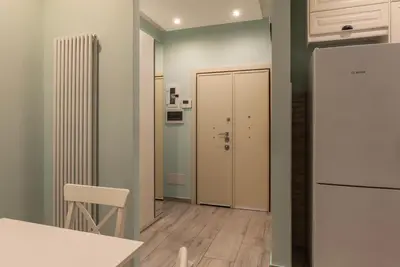 a kitchen with a white refrigerator and a table at GuestHost - Casa Mariu' a San Pietro in Rome