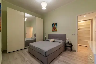 a bedroom with a bed and a mirror at GuestHost - Casa Mariu' a San Pietro in Rome