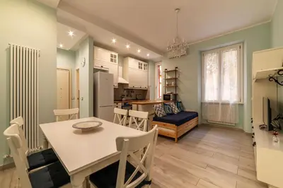 a kitchen and living room with a table and chairs at GuestHost - Casa Mariu' a San Pietro in Rome