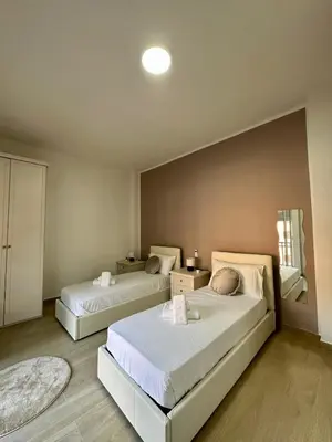 a bedroom with two beds in a room at The Roman Guesthouse in Rome
