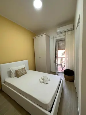 a bedroom with a large white bed in a room at The Roman Guesthouse in Rome