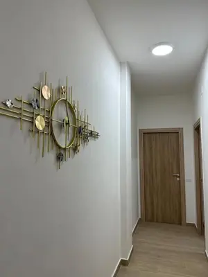 a hallway with a clock on the wall at The Roman Guesthouse in Rome