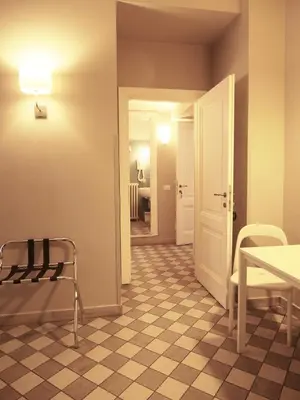 a room with a table and a chair and a door at Le Stanze di Pietro in Rome