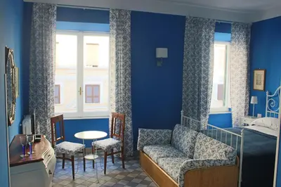 a bedroom with a bed and a couch and a table at Le Stanze di Pietro in Rome