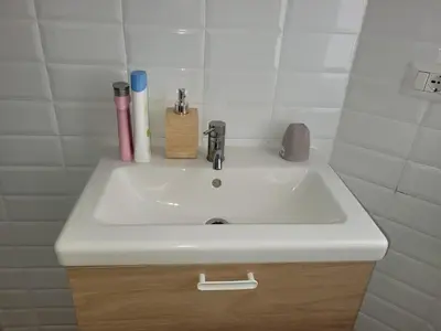 a white sink with toothbrushes and other items on it at in the garden in Rome