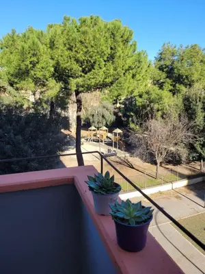a balcony with two potted plants on a ledge at in the garden in Rome